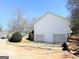 Rear exterior view of a two car garage with a concrete driveway, showcasing a clean and functional design at 209 East Wilson St # 25, Villa Rica, GA 30180