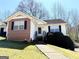 Cozy one-story house featuring vinyl siding, brick accents, manicured landscaping, and charming front entrance at 209 East Wilson St # 25, Villa Rica, GA 30180