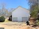 Rear exterior showing a two car garage with concrete driveway and simple landscaping at 209 East Wilson St # 25, Villa Rica, GA 30180
