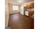 Functional kitchen featuring white appliances, brown wood cabinets, and vinyl floors at 209 East Wilson St # 25, Villa Rica, GA 30180