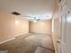 Open-concept living room featuring carpeted floors, ceiling fan and neutral colored walls at 209 East Wilson St # 25, Villa Rica, GA 30180