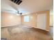 Spacious living room with carpet flooring, a ceiling fan, and a front door for easy access at 209 East Wilson St # 25, Villa Rica, GA 30180