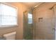 Contemporary bathroom with glass shower doors and tiled walls, paired with a window for natural light at 403 Sandown Dr, Peachtree City, GA 30269