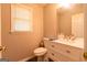 Neat bathroom featuring a vanity with drawers, a toilet and a window for natural light at 403 Sandown Dr, Peachtree City, GA 30269