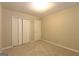 Cozy bedroom with carpet, closet, and door showing the room's simple design at 403 Sandown Dr, Peachtree City, GA 30269