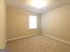 Neutral bedroom with plush carpeting, a window for natural light and ample space at 403 Sandown Dr, Peachtree City, GA 30269