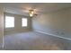 Bedroom with neutral walls and carpet with two windows at 403 Sandown Dr, Peachtree City, GA 30269