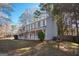 Traditional home featuring a covered porch, blue shutters, and a manicured lawn at 403 Sandown Dr, Peachtree City, GA 30269