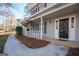 Covered front porch with white columns, nice landscaping, and an inviting entrance at 403 Sandown Dr, Peachtree City, GA 30269