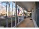 Covered front porch with white railings and an American flag at 403 Sandown Dr, Peachtree City, GA 30269