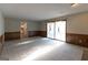 Bright living room with carpet flooring, a fireplace, and sliding glass doors at 403 Sandown Dr, Peachtree City, GA 30269