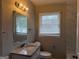 Well-lit bathroom with a granite countertop and modern mirror at 245 Carole Dr, Oxford, GA 30054