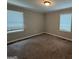 Cozy bedroom with carpet flooring and plenty of natural light at 245 Carole Dr, Oxford, GA 30054