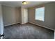 Cozy bedroom featuring plush gray carpeting and a window for natural light at 245 Carole Dr, Oxford, GA 30054