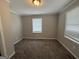 Neutral bedroom with carpeted floors and natural lighting at 245 Carole Dr, Oxford, GA 30054