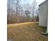 Large backyard with mature trees and a view of the wooded area at 7491 Hilltop Way, Atlanta, GA 30349