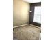 This bedroom features neutral carpeting and a window with natural light at 7491 Hilltop Way, Atlanta, GA 30349