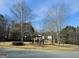 Welcoming neighborhood entrance with mature trees and well-maintained landscaping at 7491 Hilltop Way, Atlanta, GA 30349