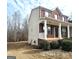 View of the side of the home showcasing the lawn, brick facade, and covered front porch at 7491 Hilltop Way, Atlanta, GA 30349