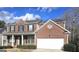 Charming two-story brick home with attached garage and well-maintained landscaping at 7491 Hilltop Way, Atlanta, GA 30349