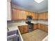 This kitchen has stainless steel appliances, oak cabinets, and tile backsplash and flooring at 7491 Hilltop Way, Atlanta, GA 30349