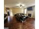 This living room offers hardwood flooring, ceiling fan and a fireplace at 7491 Hilltop Way, Atlanta, GA 30349