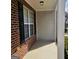 Exterior porch view showing brick and siding detail with black shutters at 7491 Hilltop Way, Atlanta, GA 30349