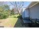A view of the backyard featuring green grass, a large tree, and a back entrance to the home at 1393 Vesta Ave, Atlanta, GA 30344