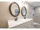 Bathroom with a dual sink vanity, framed mirrors, and a view of the shower at 1393 Vesta Ave, Atlanta, GA 30344
