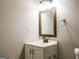 Bathroom featuring a vanity, mirror, and toilet with neutral colored walls at 1393 Vesta Ave, Atlanta, GA 30344