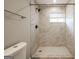 Modern bathroom showcasing a beautiful marble tiled shower with updated shower head at 1393 Vesta Ave, Atlanta, GA 30344