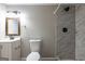 Bathroom showcasing marble tiled shower, vanity, and toilet with modern fixtures at 1393 Vesta Ave, Atlanta, GA 30344