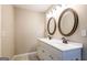 Bathroom with a dual sink vanity, decorative mirrors, and elegant fixtures at 1393 Vesta Ave, Atlanta, GA 30344
