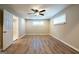 Spacious bedroom with wood-look floors, a ceiling fan, and plenty of natural light from the window at 1393 Vesta Ave, Atlanta, GA 30344