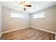 Bedroom featuring two windows, wood floors, neutral walls, and a ceiling fan at 1393 Vesta Ave, Atlanta, GA 30344