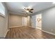 Bedroom with wood-look floors, ceiling fan, view into ensuite bathroom, and a closet at 1393 Vesta Ave, Atlanta, GA 30344