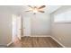Bedroom featuring wood floors, neutral walls, and a doorway to another room at 1393 Vesta Ave, Atlanta, GA 30344