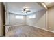 Bedroom featuring wood-look flooring, ceiling fan, and two windows providing ample natural light at 1393 Vesta Ave, Atlanta, GA 30344