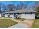 Charming single-story home with a painted brick exterior, blue shutters and a well-manicured lawn at 1393 Vesta Ave, Atlanta, GA 30344