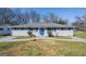 Charming single-story home with blue shutters and a walkway leading to the front door at 1393 Vesta Ave, Atlanta, GA 30344