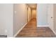 Hallway with wood-look flooring, neutral walls, and white trim leading to various rooms in the home at 1393 Vesta Ave, Atlanta, GA 30344
