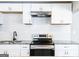 Modern kitchen features white cabinets, granite countertops, stainless steel appliances, and a subway tile backsplash at 1393 Vesta Ave, Atlanta, GA 30344
