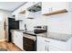 Updated kitchen with granite counters, stainless appliances, white cabinets and subway tile at 1393 Vesta Ave, Atlanta, GA 30344