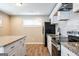 Kitchen featuring stainless steel appliances, granite counters, subway tile backsplash, and island at 1393 Vesta Ave, Atlanta, GA 30344