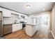 Remodeled kitchen with white cabinets, stainless appliances, granite countertops and hardwood floors at 1393 Vesta Ave, Atlanta, GA 30344