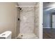 Bathroom showing the tiled shower, toilet, and neutral colored walls at 1393 Vesta Ave, Atlanta, GA 30344
