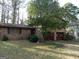 Charming brick home featuring an expansive front yard and attached garage at 3045 Weslock Cir, Decatur, GA 30034