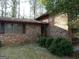 Brick home with an attached garage, shuttered windows, and mature landscaping at 3045 Weslock Cir, Decatur, GA 30034