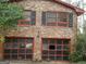 Close up of a two-car garage with broken doors on a brick home at 3045 Weslock Cir, Decatur, GA 30034