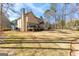 Expansive backyard view featuring a well-maintained lawn and a two-story home at 423 Holly Grove Church Rd, Peachtree City, GA 30269